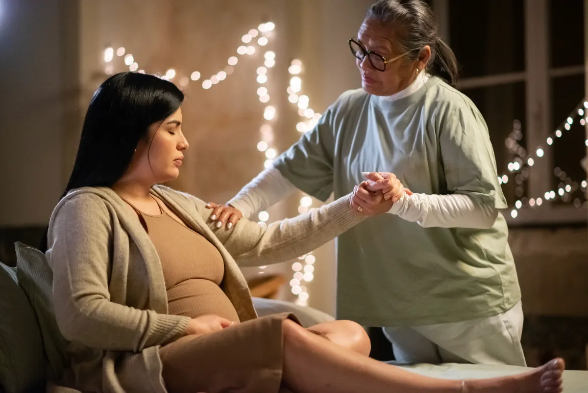 Doula providing labor support to a mother
